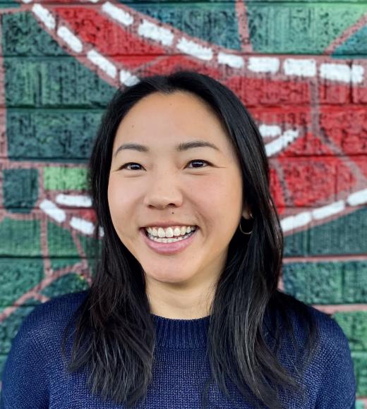 Woman smiling wearing a dark blue shirt